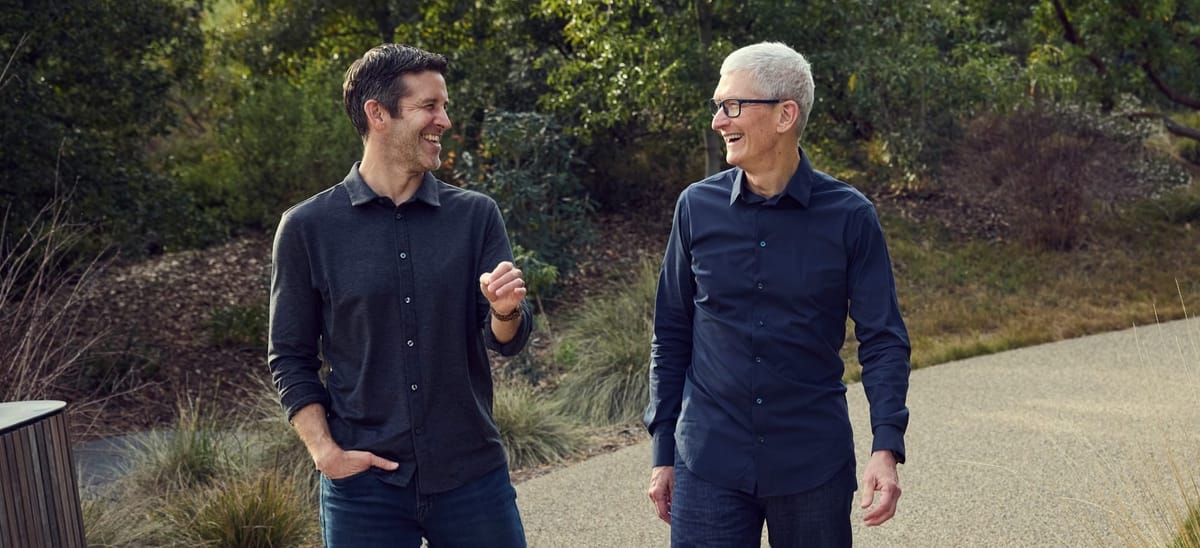 photograph of John Ternus and Tim Cook waling in (presumably) Apple Park